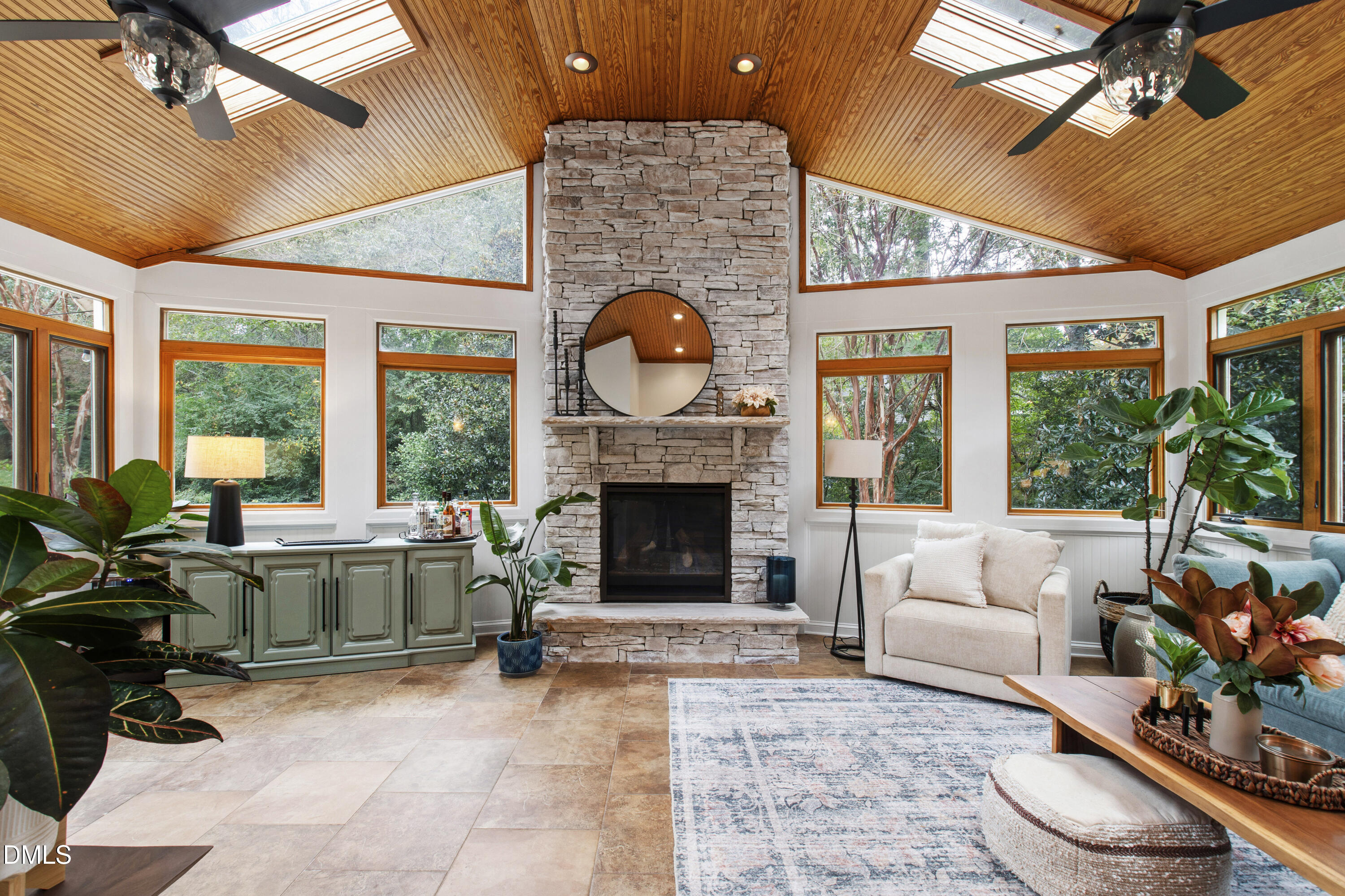 7501 Panther Branch Drive Raleigh, NC 27612 - Photo 16 of 56 a living room with furniture a fireplace and a floor to ceiling window