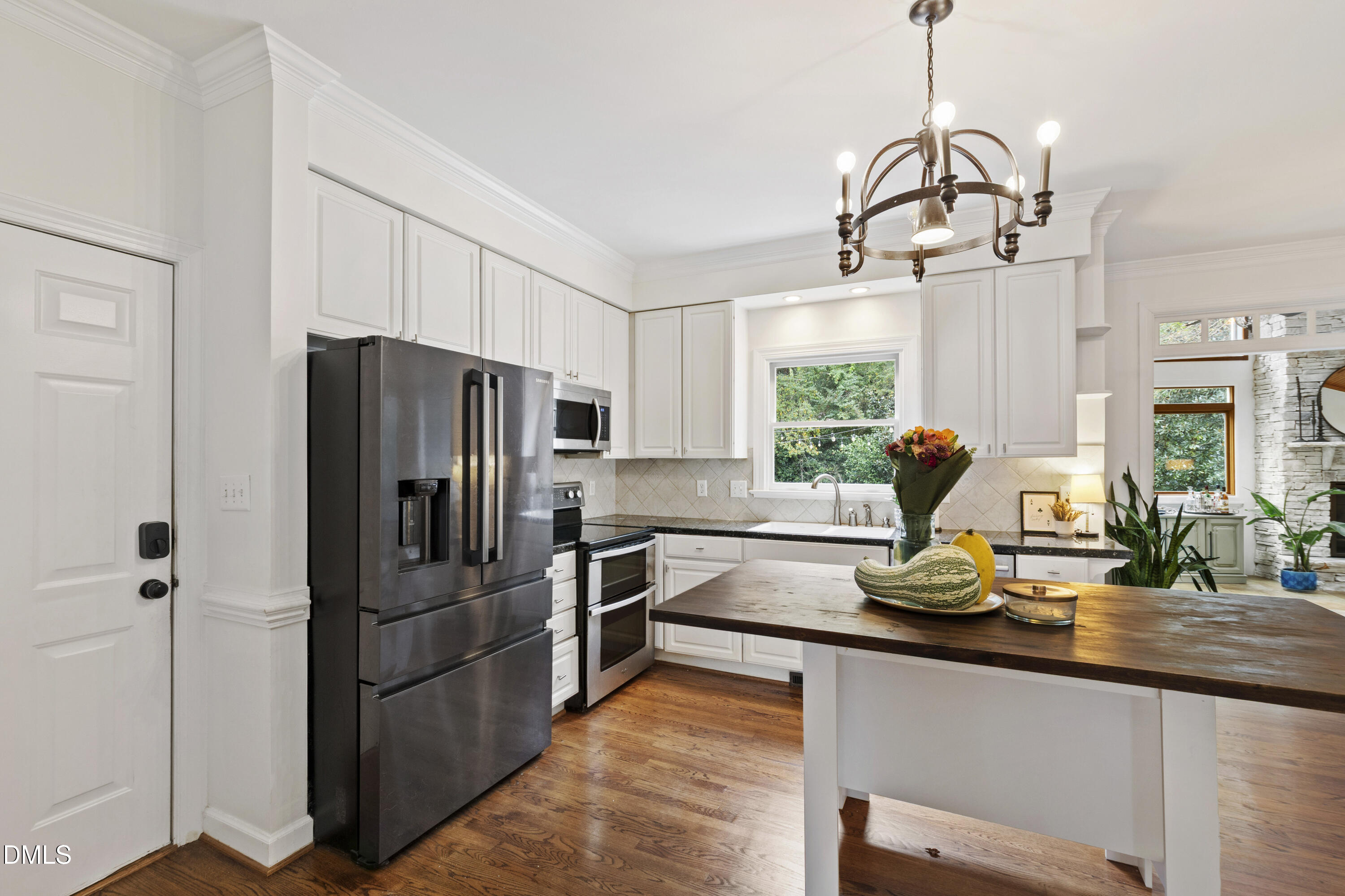 7501 Panther Branch Drive Raleigh, NC 27612 - Photo 22 of 56 a kitchen with kitchen island white cabinets and stainless steel appliances