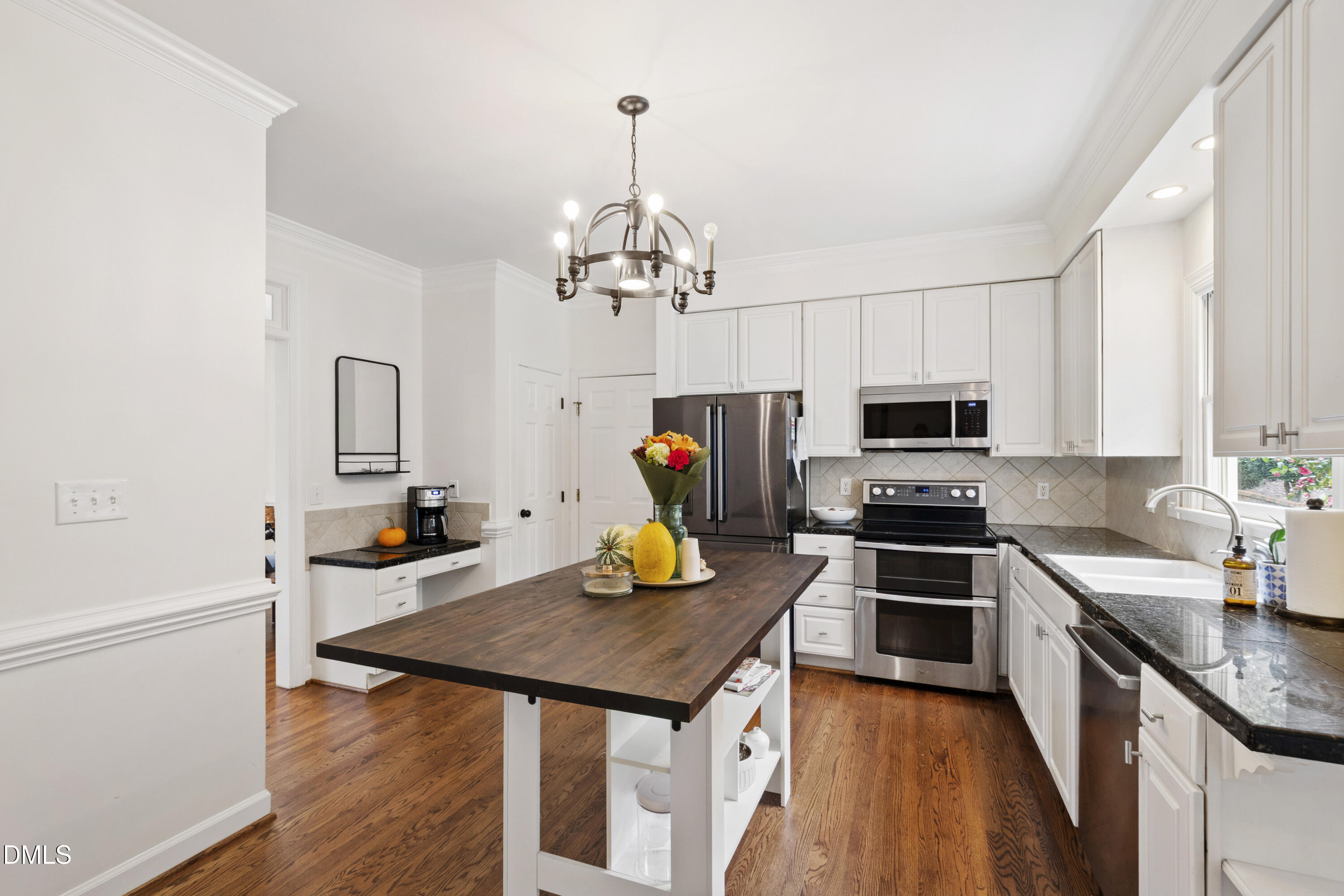 7501 Panther Branch Drive Raleigh, NC 27612 - Photo 25 of 56 a kitchen with stainless steel appliances a stove sink microwave and cabinets
