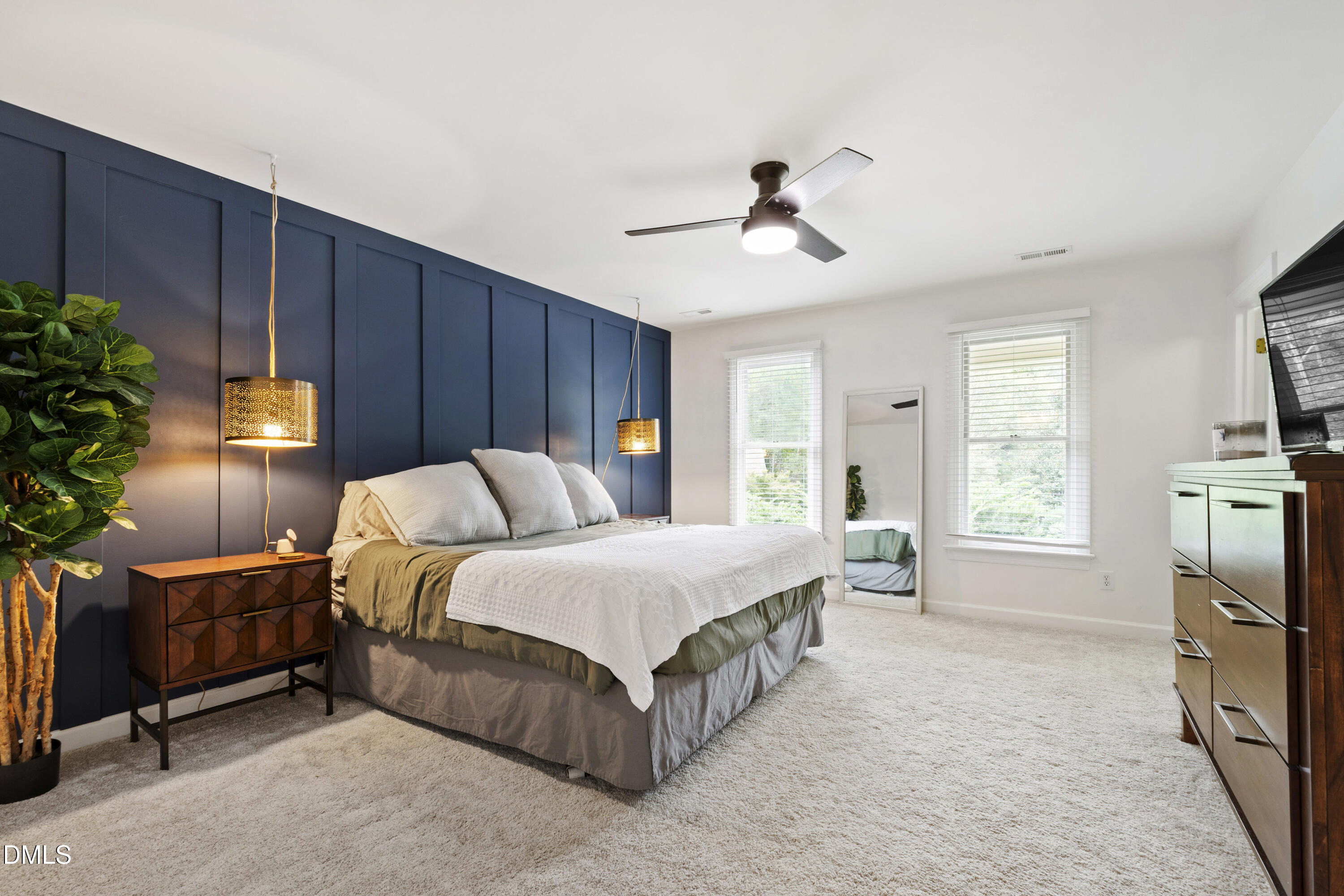 7501 Panther Branch Drive Raleigh, NC 27612 - Photo 28 of 56 a spacious bedroom with a bed a couch and potted plant on the dresser