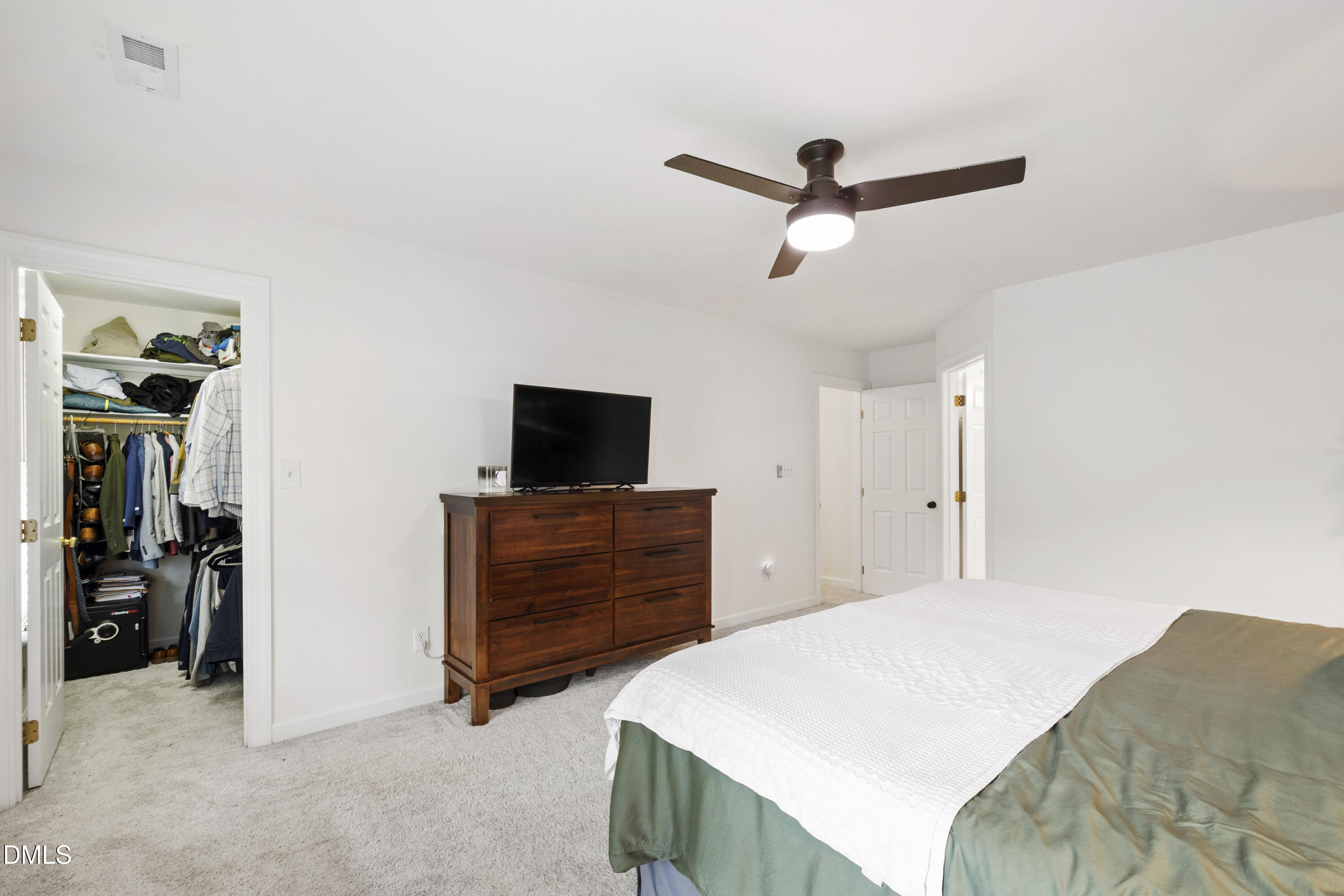 7501 Panther Branch Drive Raleigh, NC 27612 - Photo 29 of 56 a bedroom with a bed and a television