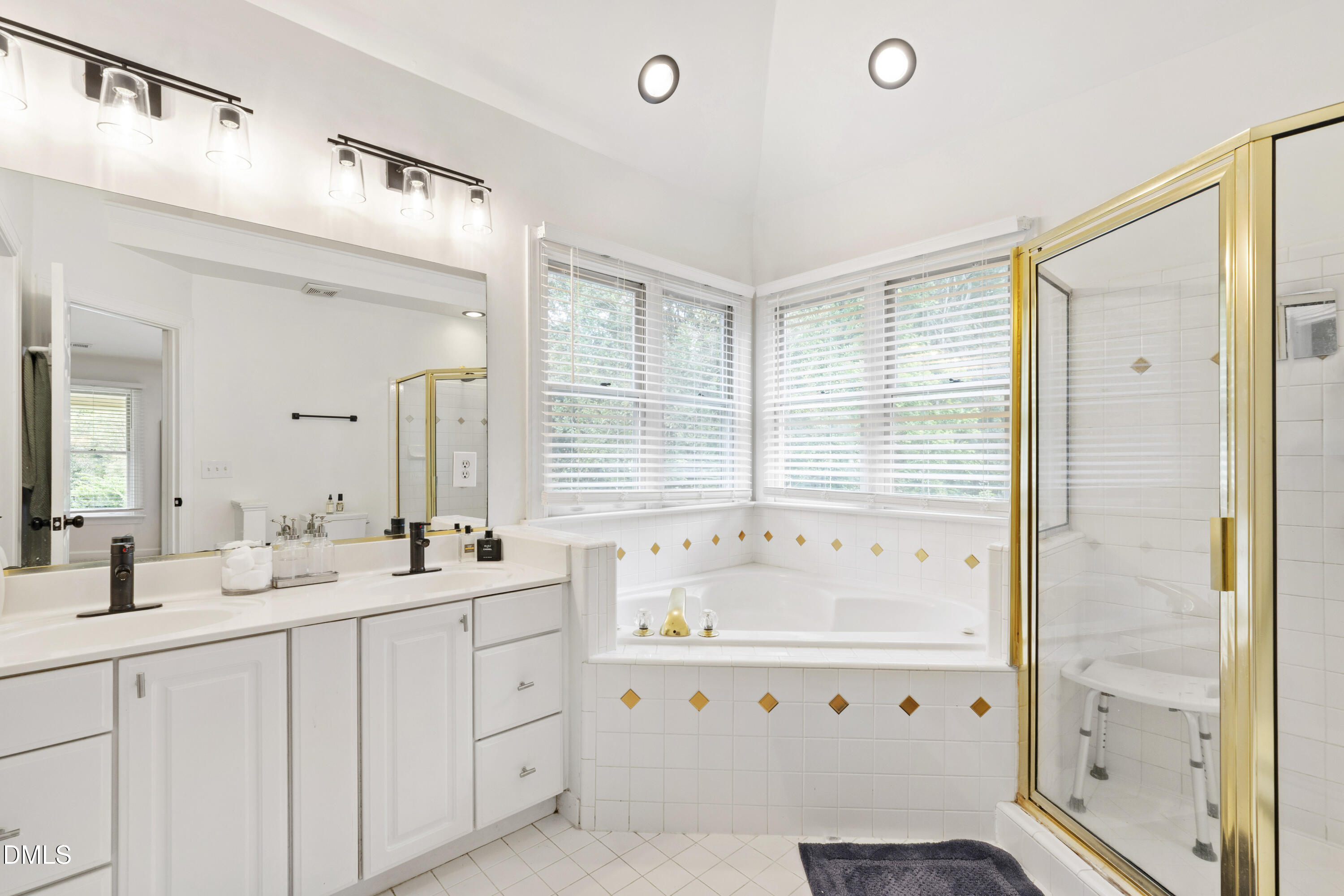 7501 Panther Branch Drive Raleigh, NC 27612 - Photo 30 of 56 a spacious bathroom with double vanity a mirror a bathtub and a shower
