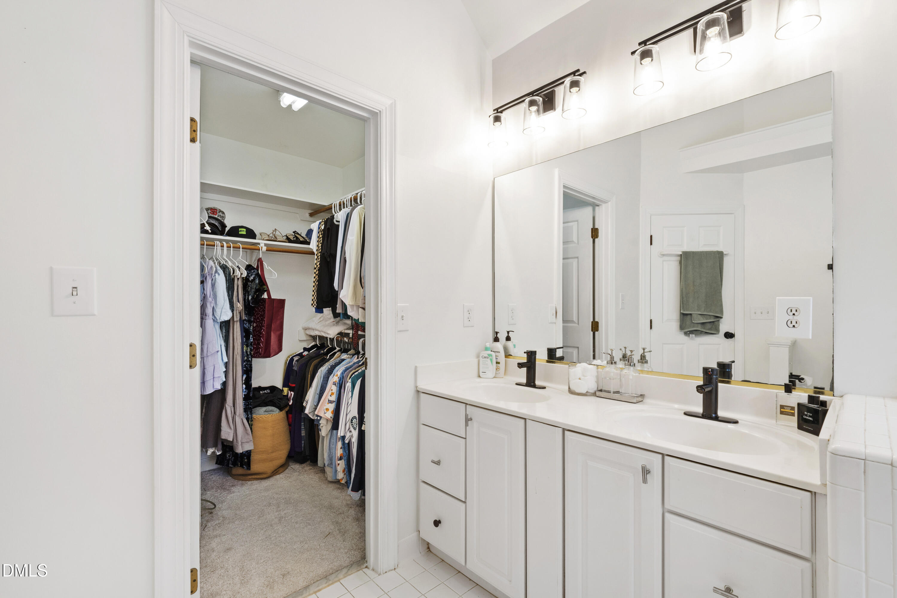7501 Panther Branch Drive Raleigh, NC 27612 - Photo 31 of 56 a en suite bathroom with double sink and a mirror