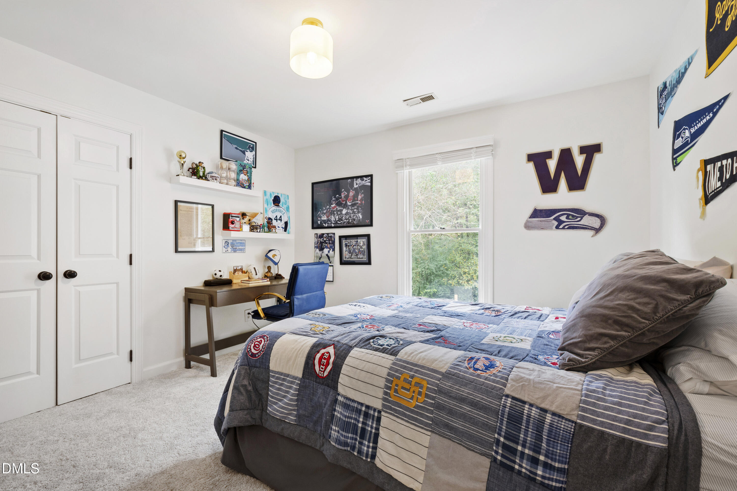 7501 Panther Branch Drive Raleigh, NC 27612 - Photo 39 of 56 a bedroom with a bed and a window