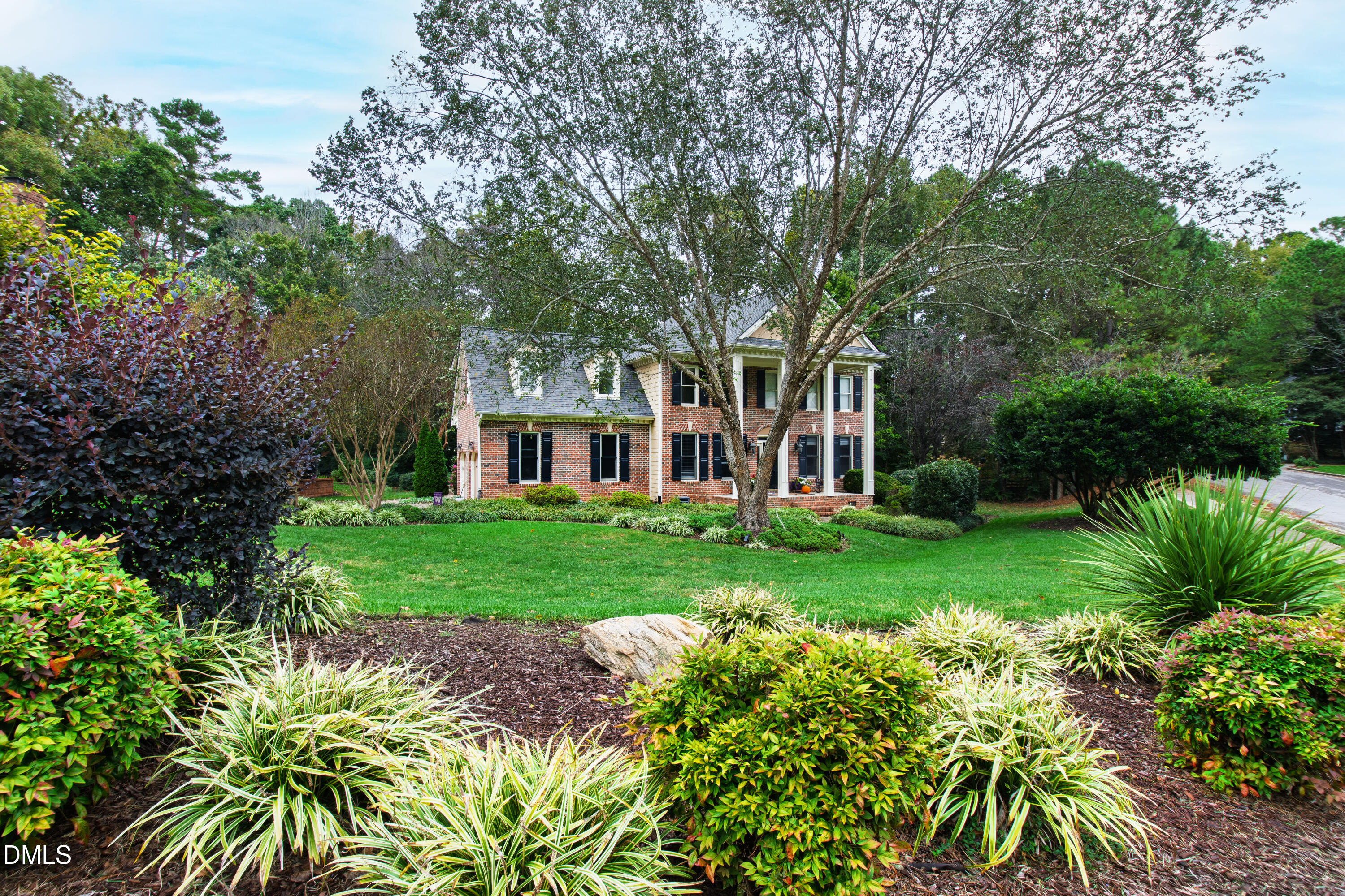 7501 Panther Branch Drive Raleigh, NC 27612 - Photo 52 of 56 a view of a yard with plants and large trees