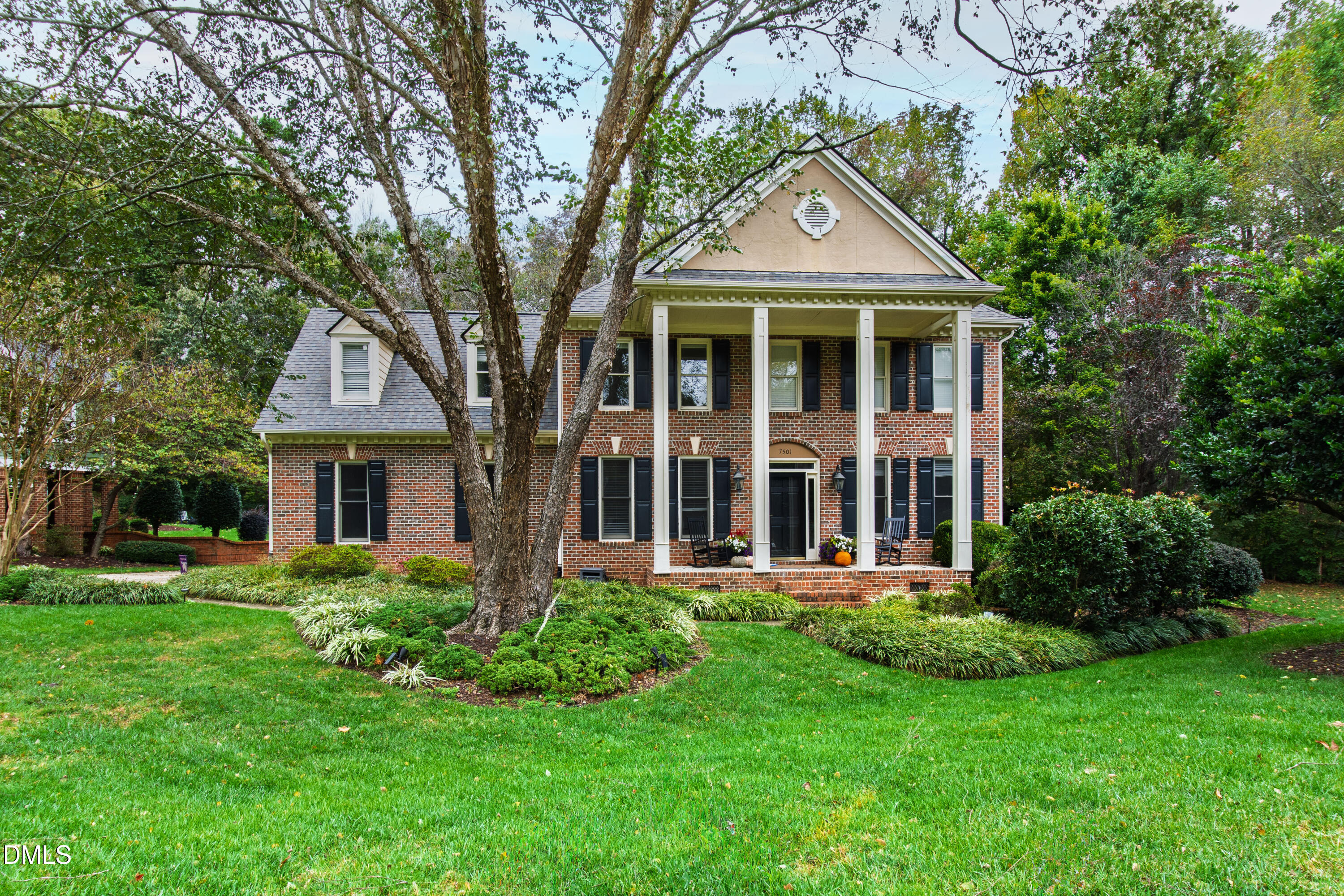 7501 Panther Branch Drive Raleigh, NC 27612 - Photo 55 of 56 a front view of a house with a yard and trees