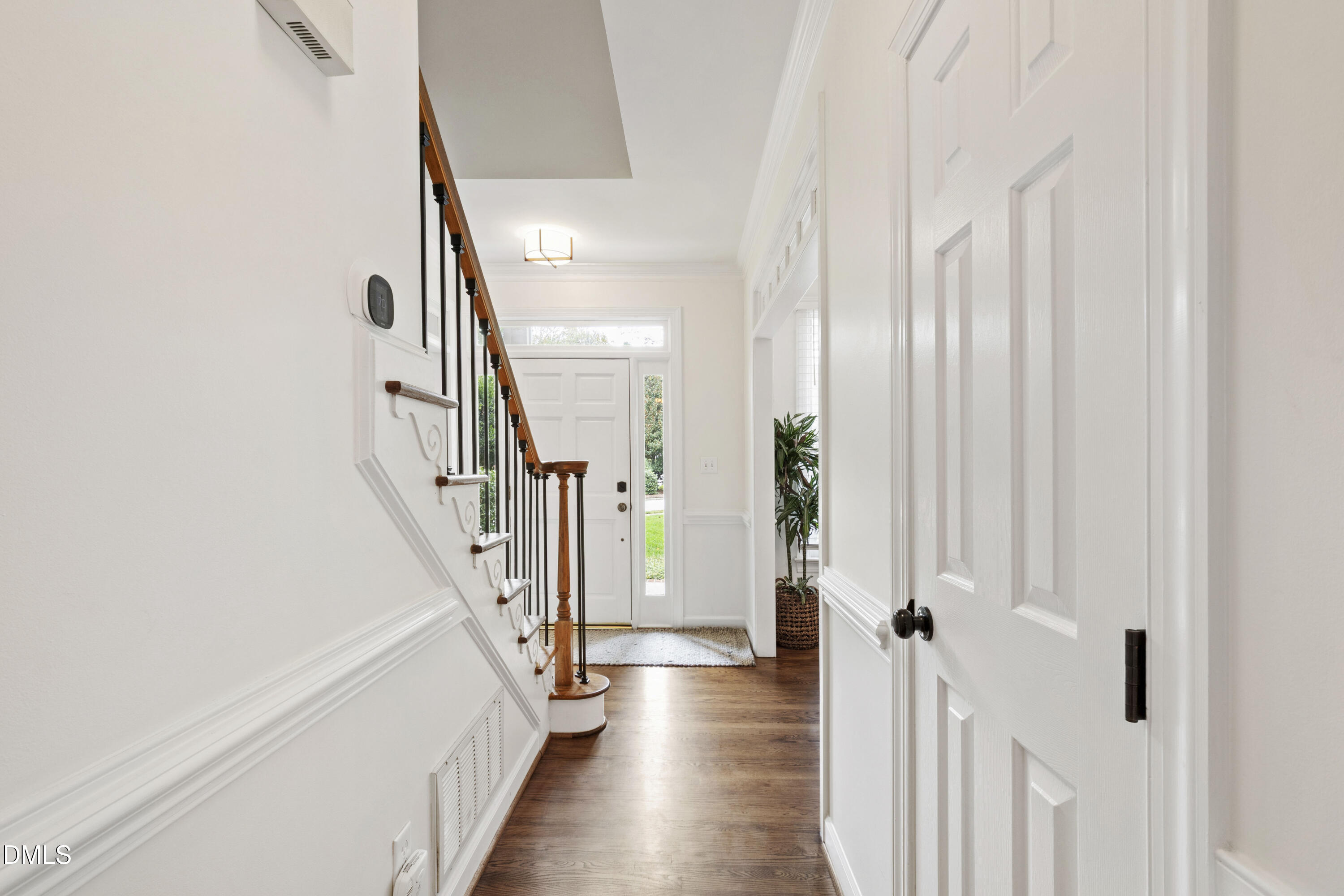 7501 Panther Branch Drive Raleigh, NC 27612 - Photo 9 of 56 a view of a hallway with wooden floor and staircase