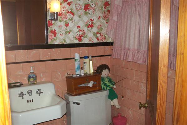 111 Goodwin Street Springfield, MA 01151 - Photo 14 of 19 a bathroom with a painting on the wall and a shower curtain