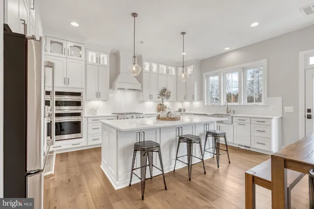 a kitchen with stainless steel appliances a refrigerator and cabinets
