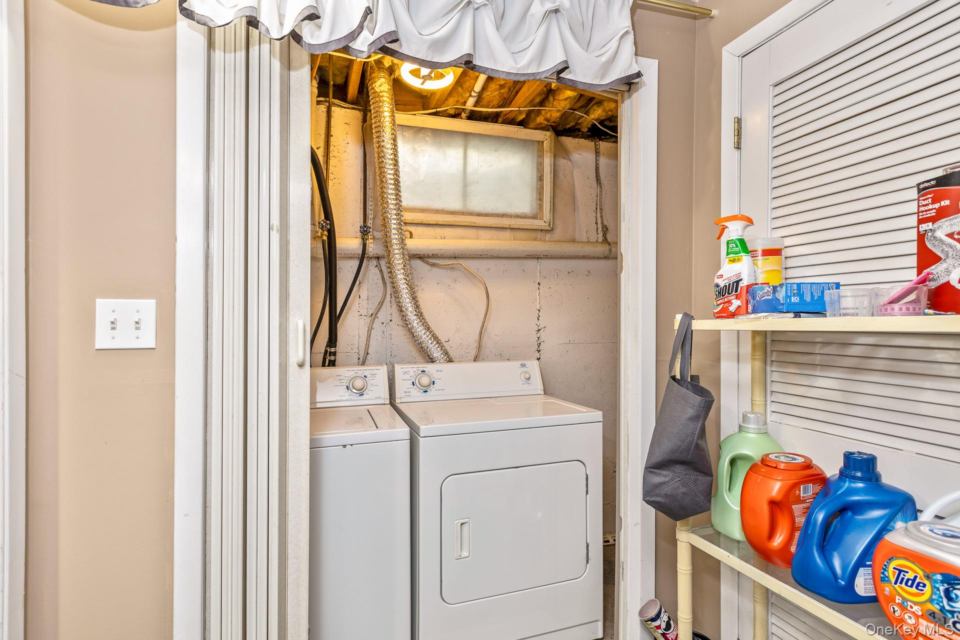 17 Stone Commons Yaphank, NY 11980 - Photo 24 of 31 Dedicated laundry area featuring a washer and dryer, exposed ceiling joists, and a utility window