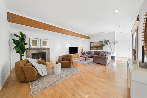 a living room with furniture a fireplace and a potted plant