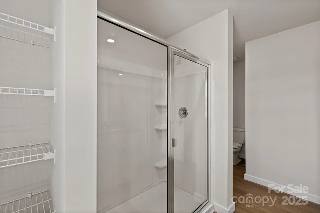 a bathroom with a glass shower door