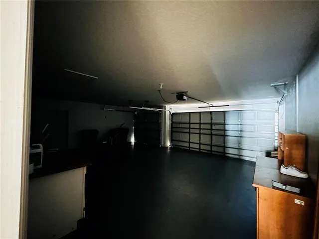 a view of room with stairs and wooden floor