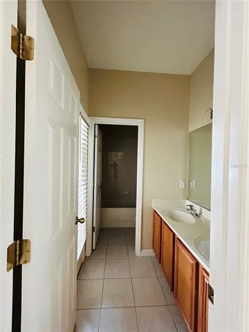 a hallway with a sink and cabinets