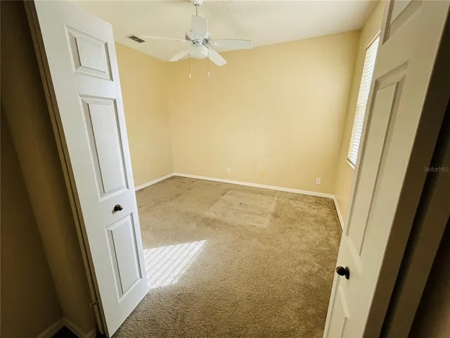 a large white bathroom with a tub a sink and a mirror