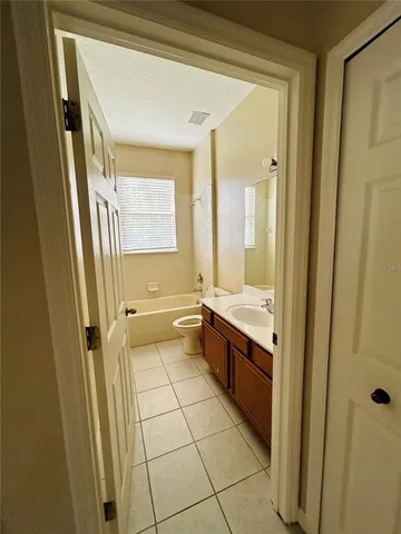 a view of hallway with a bathroom
