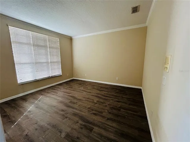 a view of a livingroom with furniture wooden floor and window