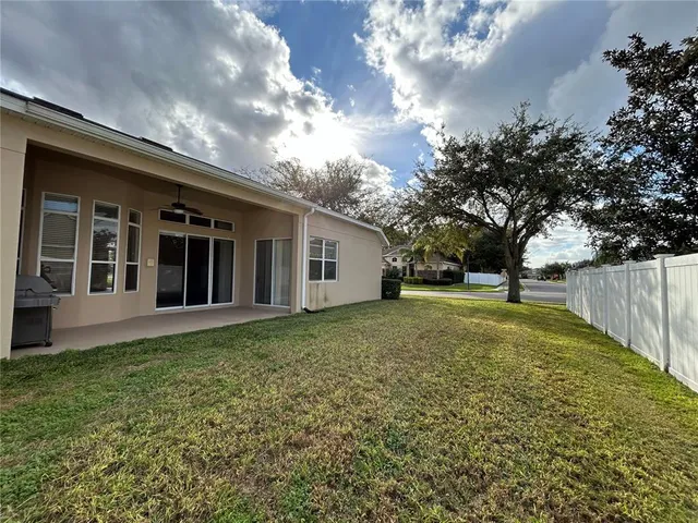a view of a house with backyard and garden