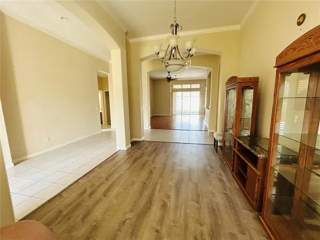a view of a room with wooden floor and lots of windows