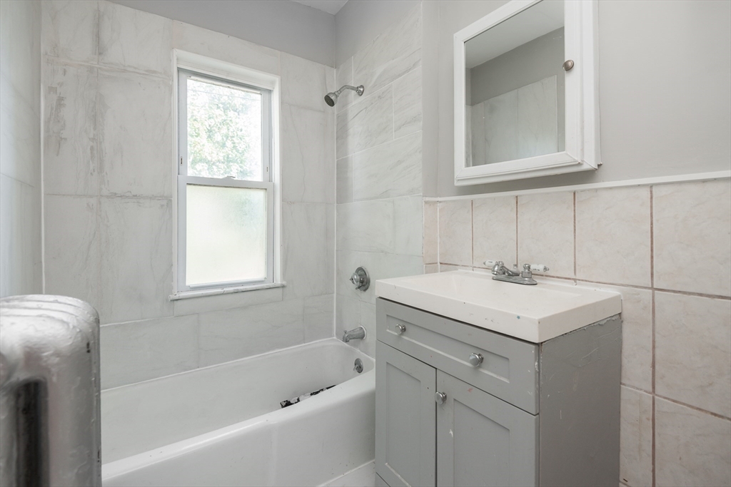 112 Brush Hill Road Milton, MA 02186 - Photo 17 of 42 a bathroom with a sink toilet vanity and tub