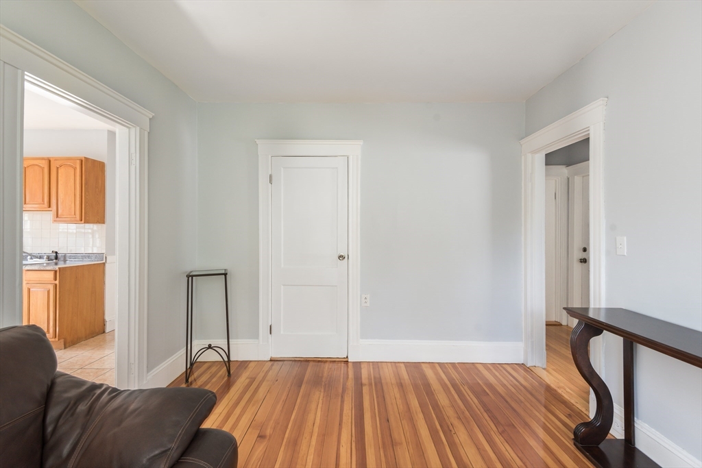 112 Brush Hill Road Milton, MA 02186 - Photo 28 of 42 a bedroom with a bed and wooden floor