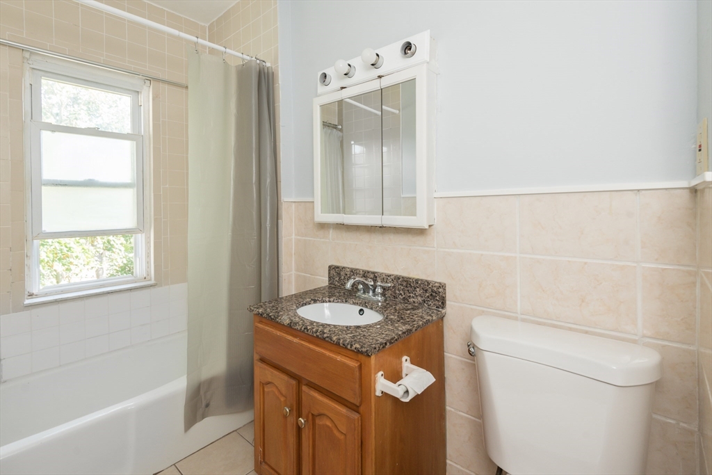 112 Brush Hill Road Milton, MA 02186 - Photo 30 of 42 a bathroom with a granite countertop sink a toilet and shower