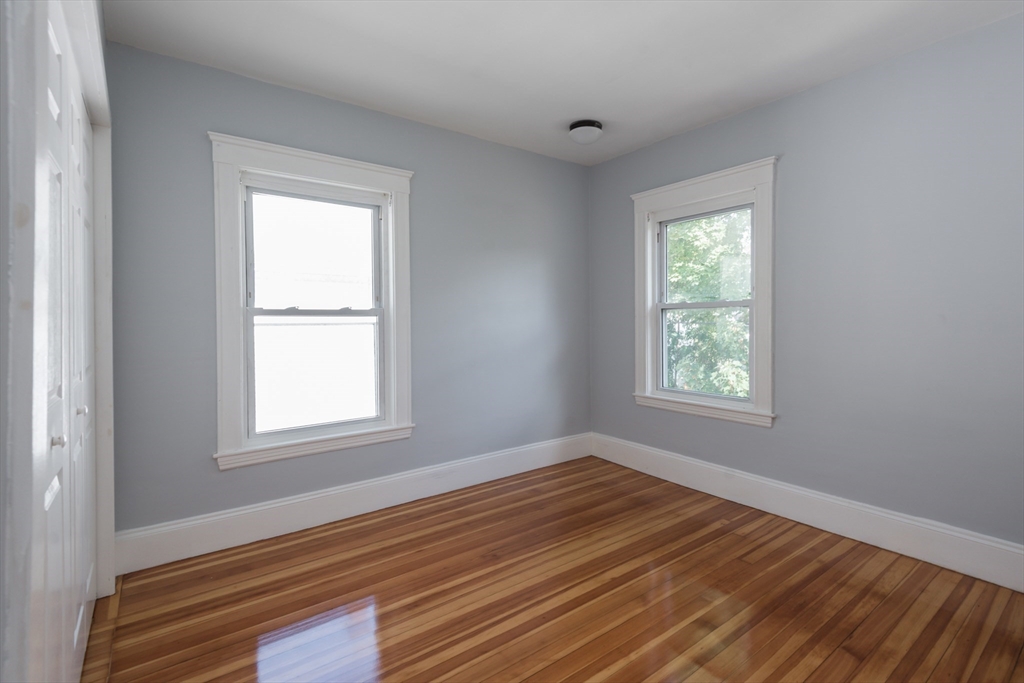 112 Brush Hill Road Milton, MA 02186 - Photo 31 of 42 a view of an empty room with wooden floor and a window