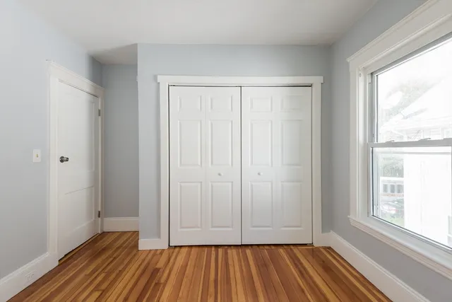 a view of room with window and hardwood floor