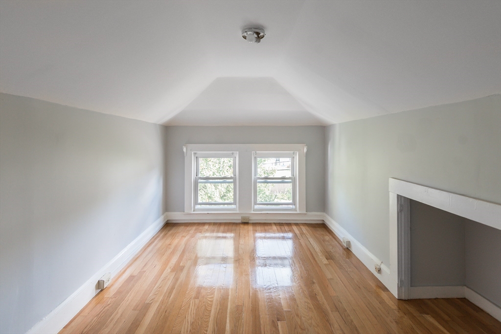 112 Brush Hill Road Milton, MA 02186 - Photo 38 of 42 an empty room with wooden floor and windows