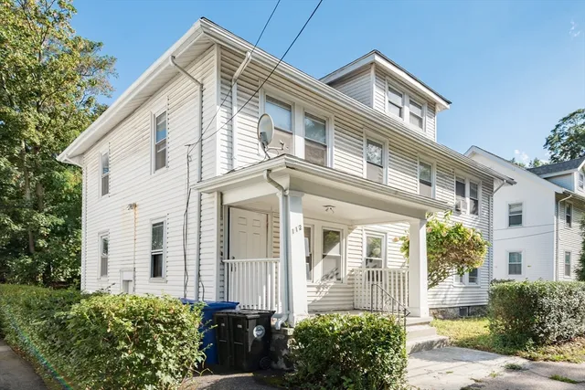 a front view of a house with a garden