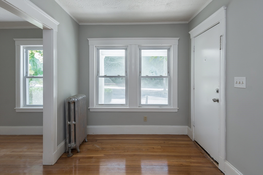 112 Brush Hill Road Milton, MA 02186 - Photo 9 of 42 an empty room with wooden floor and windows