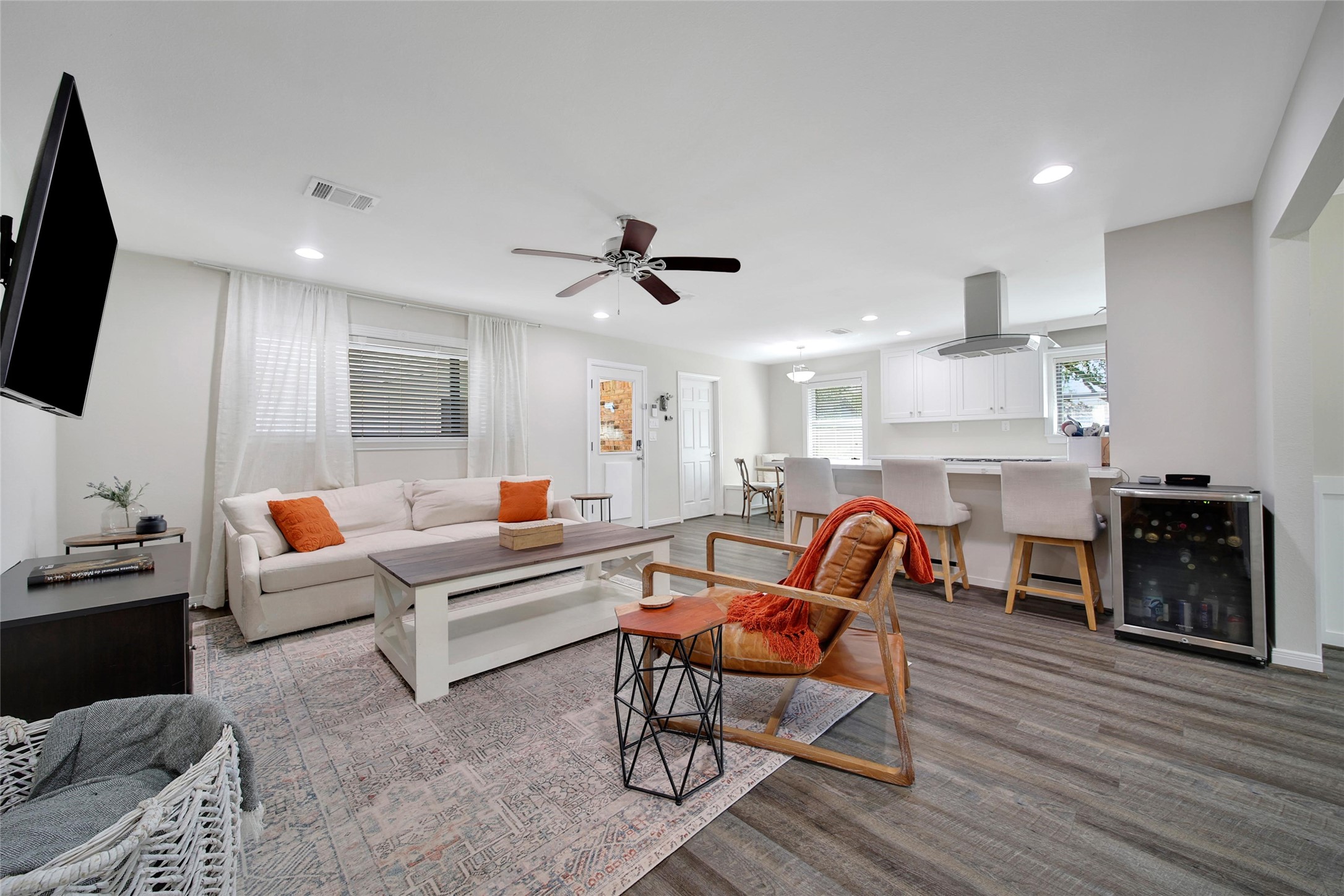 4402 Fallbrook Drive Houston, TX 77018 - Photo 14 of 29 Bright open-concept living room featuring modern finishes, abundant natural light, and direct views into the kitchen and breakfast area.