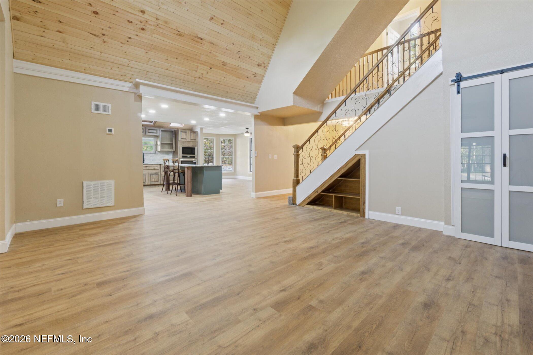 3121 Lannie Road Jacksonville, FL 32218 - Photo 14 of 68 a view of empty room with wooden floor and stairs