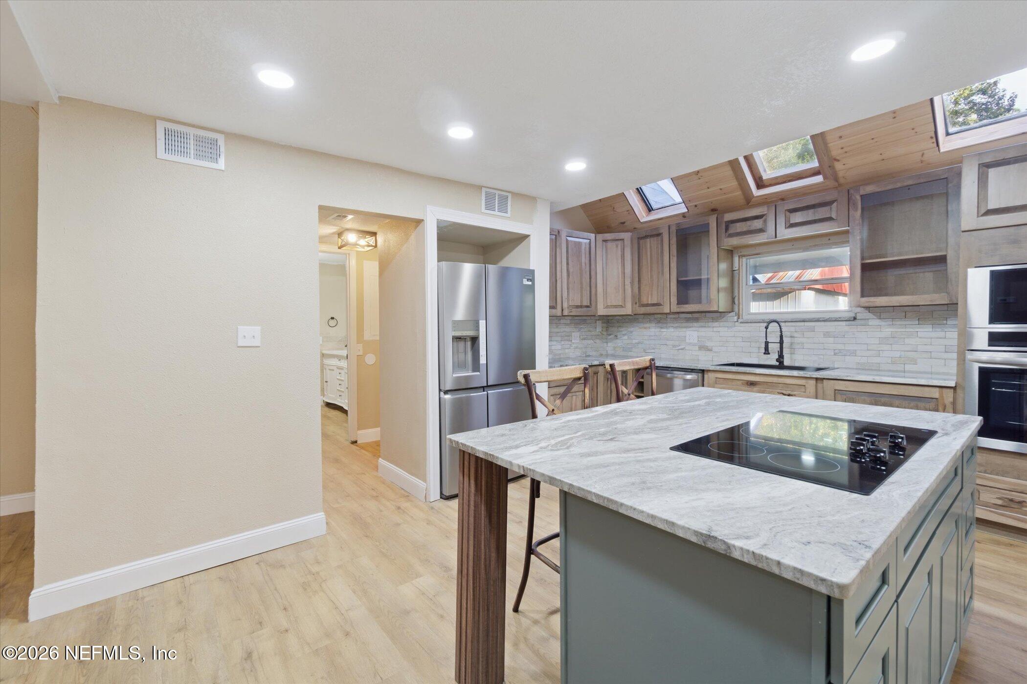 3121 Lannie Road Jacksonville, FL 32218 - Photo 18 of 68 a kitchen that has a sink a refrigerator and a cabinets