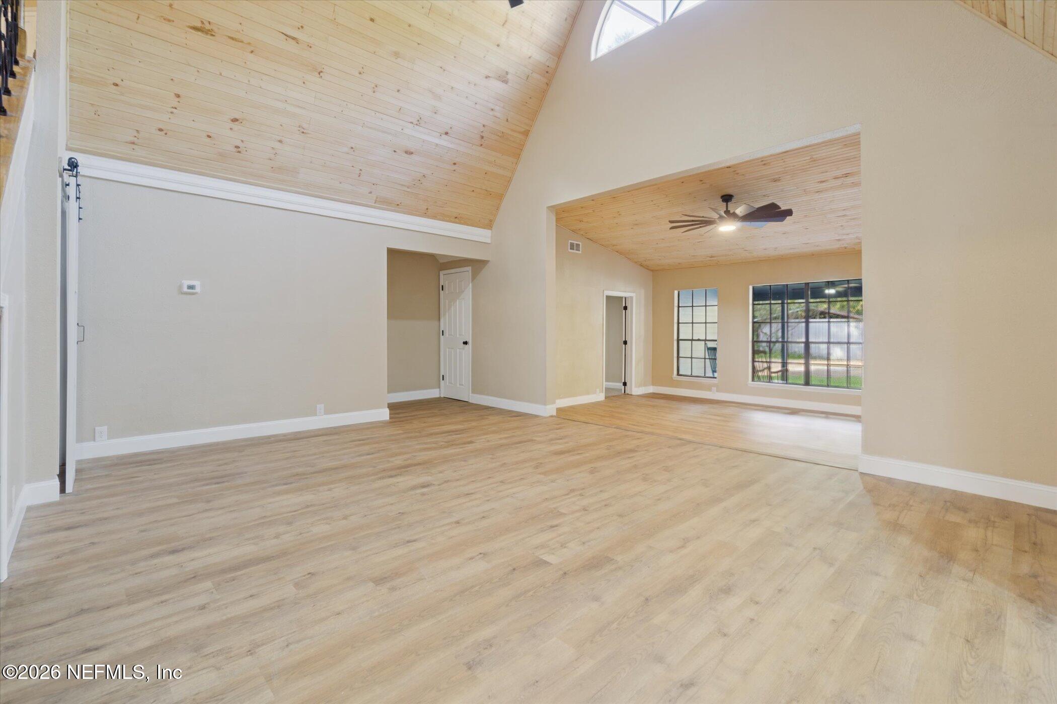3121 Lannie Road Jacksonville, FL 32218 - Photo 22 of 68 a view of an empty room with wooden floor and a window
