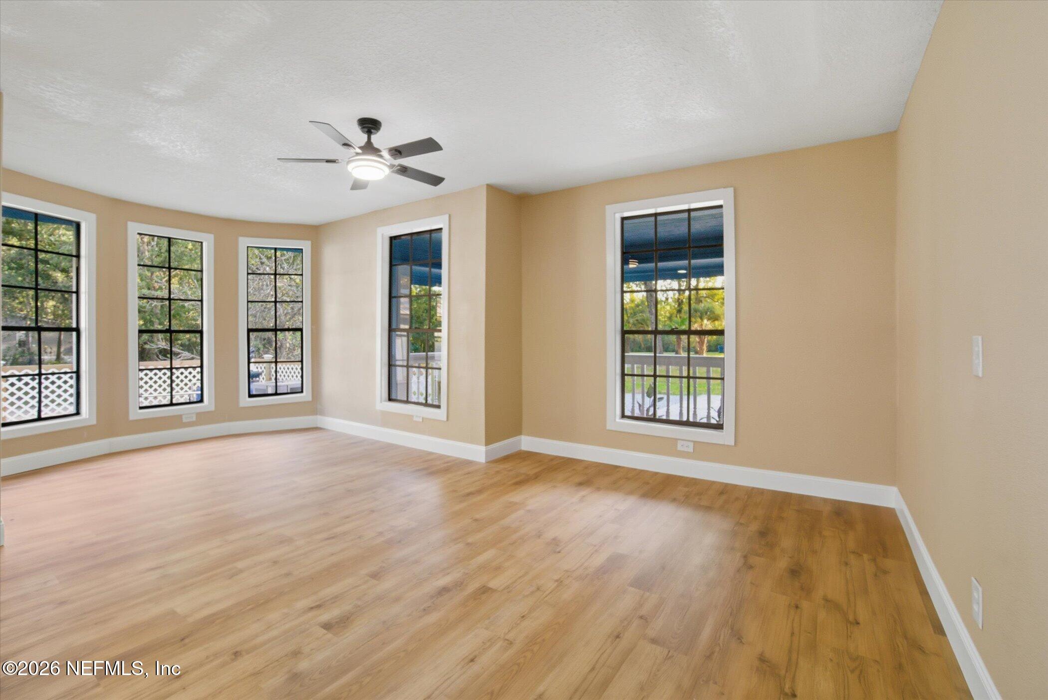 3121 Lannie Road Jacksonville, FL 32218 - Photo 25 of 68 a view of an empty room with a window and wooden floor