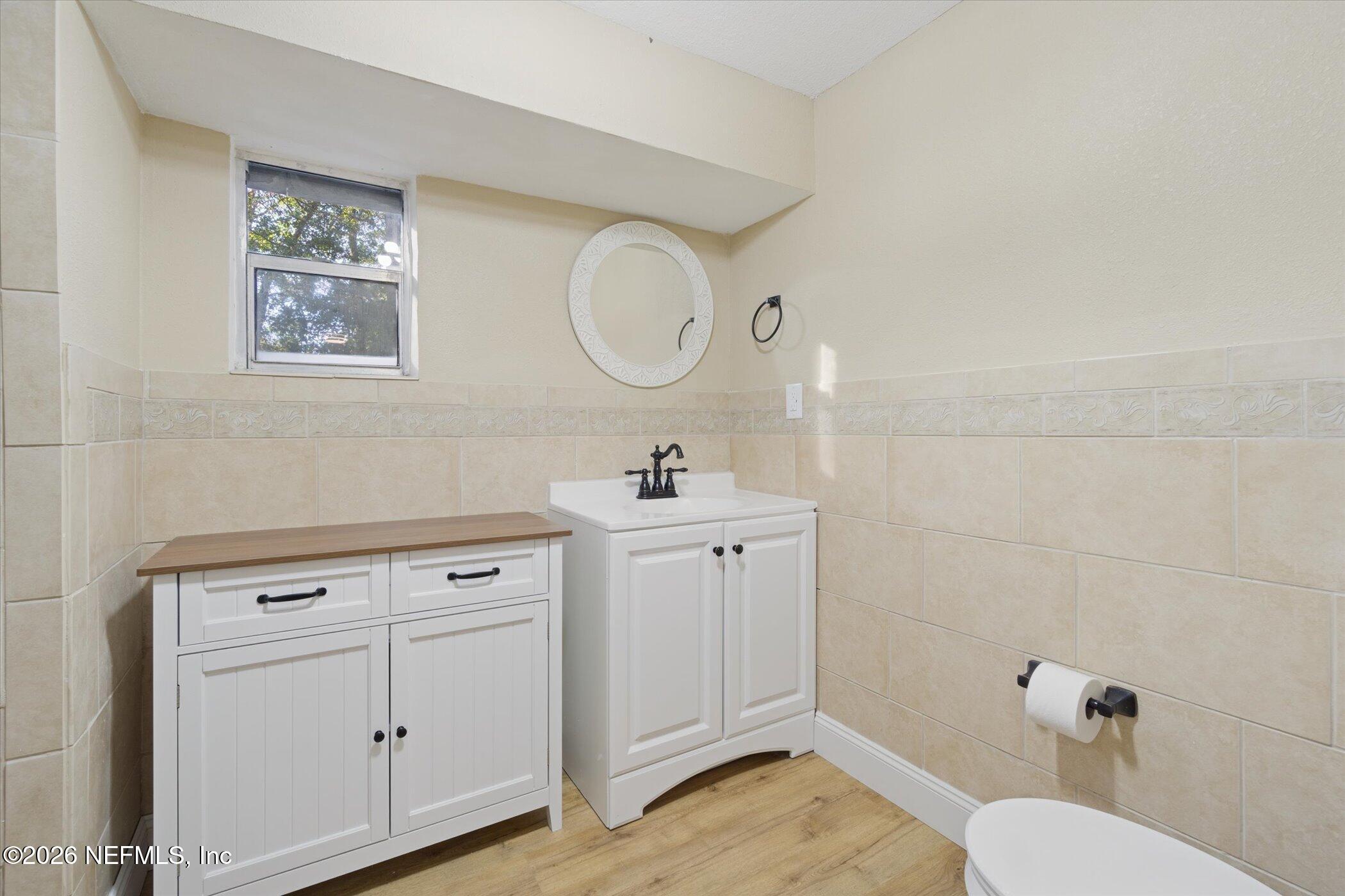 3121 Lannie Road Jacksonville, FL 32218 - Photo 30 of 68 a bathroom with a sink mirror and vanity