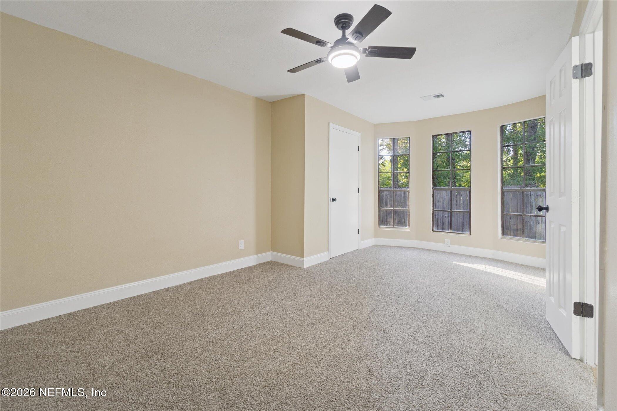 3121 Lannie Road Jacksonville, FL 32218 - Photo 32 of 68 an empty room with windows and fan