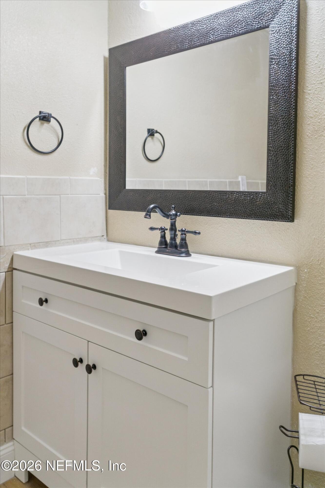 3121 Lannie Road Jacksonville, FL 32218 - Photo 33 of 68 a bathroom with a sink and a mirror