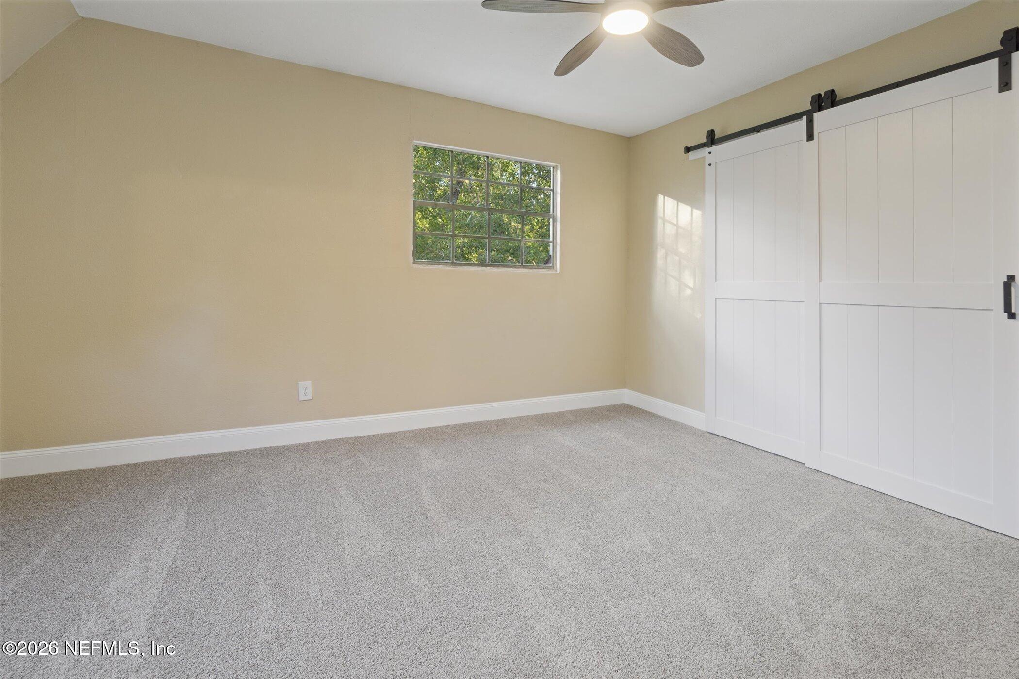 3121 Lannie Road Jacksonville, FL 32218 - Photo 40 of 68 an empty room with a ceiling fan and a window