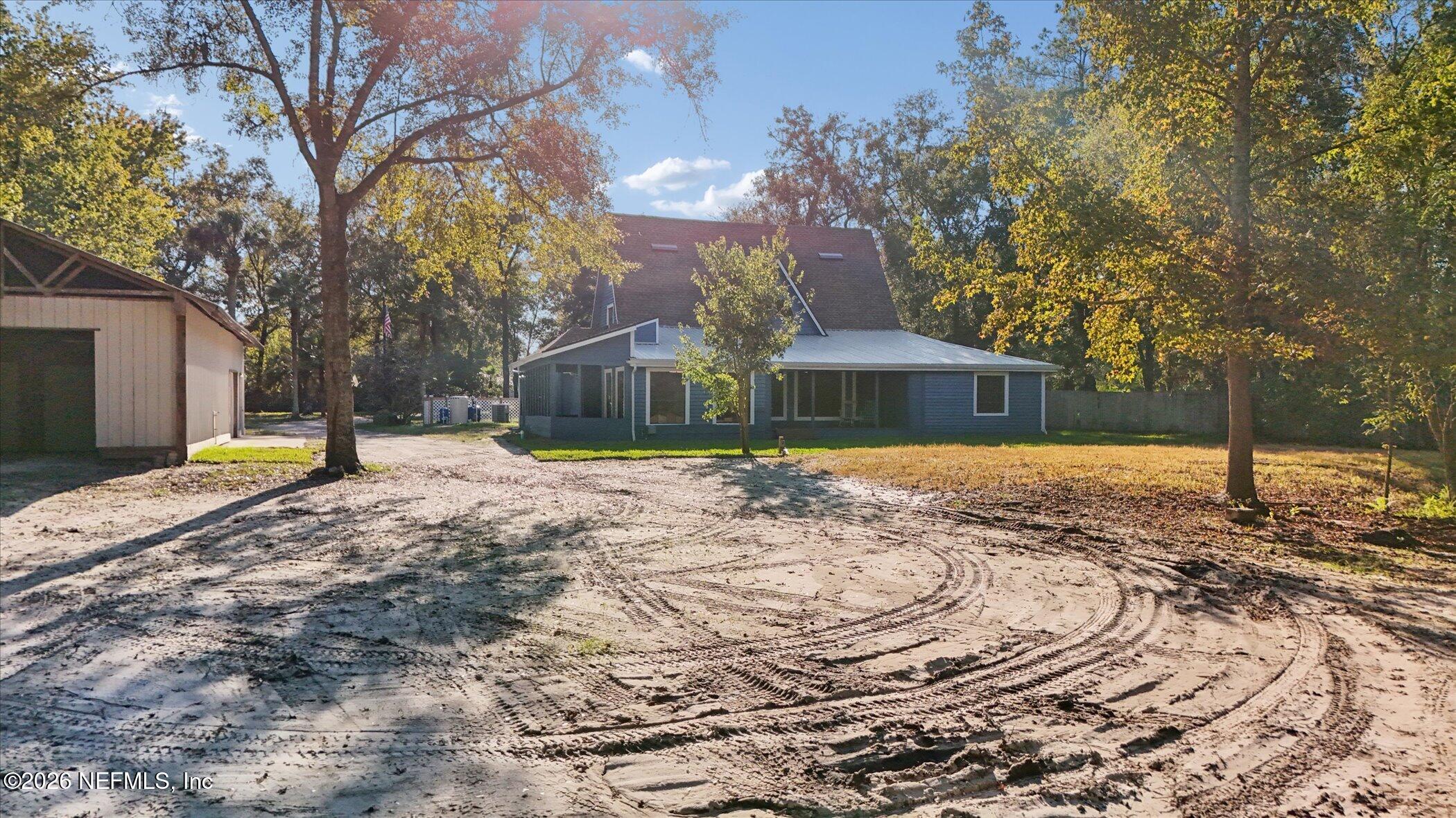3121 Lannie Road Jacksonville, FL 32218 - Photo 58 of 68 a front view of house with yard and trees around