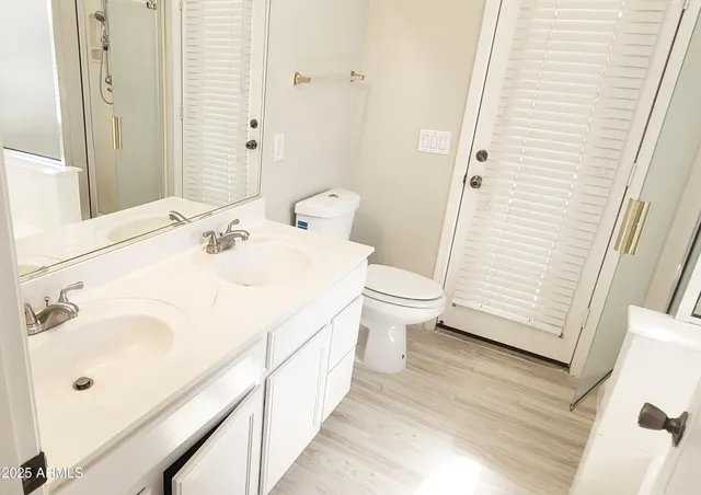a bathroom with a sink a toilet and shower curtain