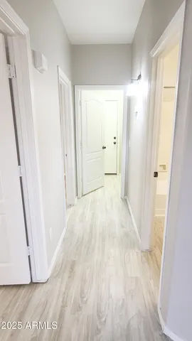 a view of a room with wooden floor and staircase