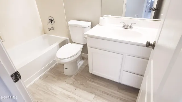 a white toilet sitting next to a bathroom sink