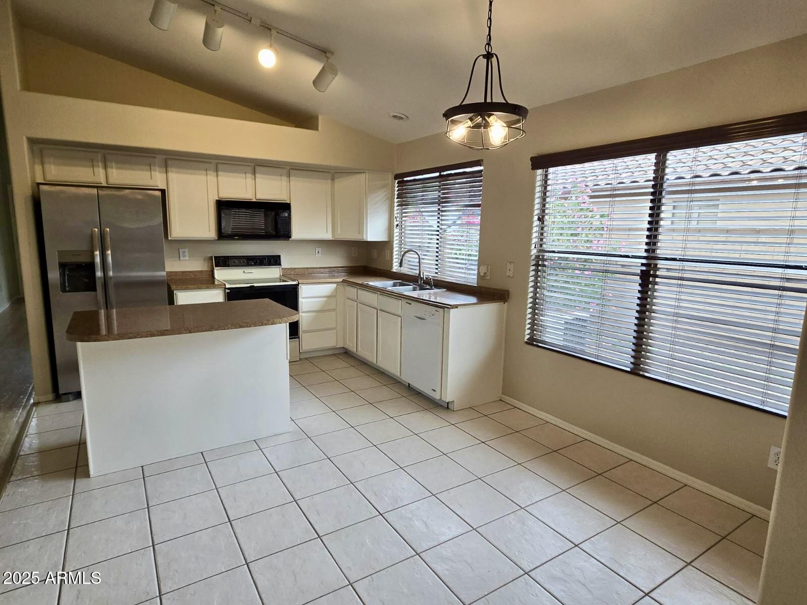 1729 East Pony Lane Gilbert, AZ 85295 - Photo 4 of 31 a kitchen with stainless steel appliances granite countertop a stove top oven a sink a counter top space and cabinets