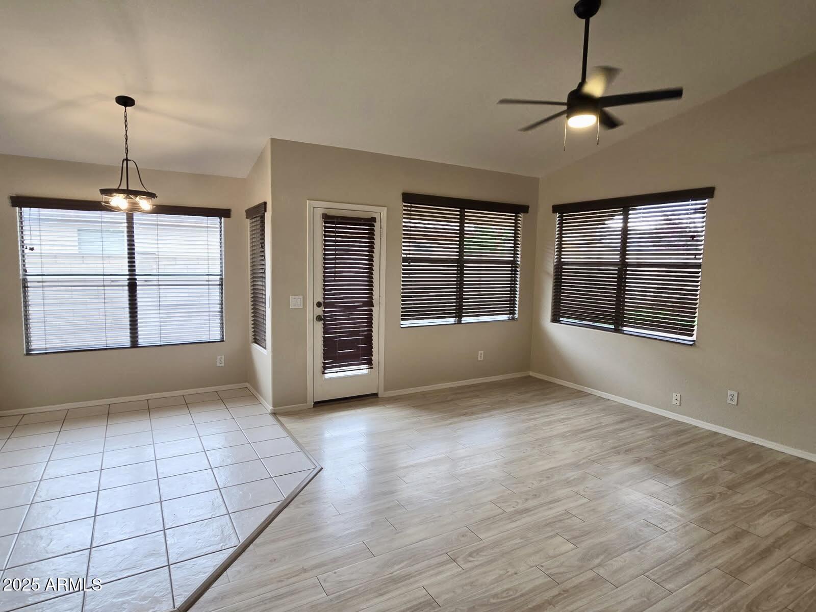 1729 East Pony Lane Gilbert, AZ 85295 - Photo 7 of 31 a view of an empty room with a window and chandelier