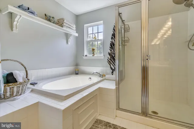 a bathroom with a sink a mirror and shower