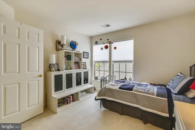 a bedroom with furniture and a window