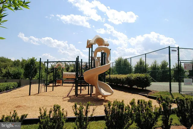 a view of a park with iron fence