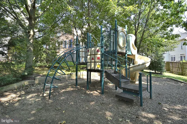 a view of chairs and bench in the backyard